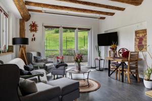 a living room with a couch and chairs and a table at Fewo Schwarzwaldflair mit Eventraum in Hofsgrund