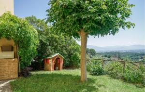 a red dog house sitting next to a tree at Beautiful Home In Serravalle Pistoiese in Serravalle Pistoiese