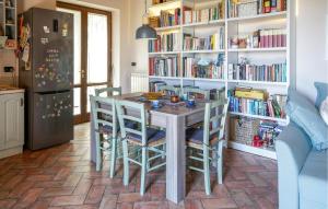a kitchen with a table and chairs and a book shelf at Beautiful Home In Serravalle Pistoiese in Serravalle Pistoiese +8 photos