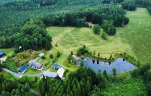 an aerial view of a farm with a house and a lake at Lovely Home In Örkelljunga With Sauna in Orkelljunga +14 photos