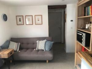 a living room with a couch and a book shelf at Fabulous location, Multipass provider in Morzine