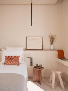 a bedroom with a bed and a table at Hôtel Liautaud Rooftop Cassis in Cassis
