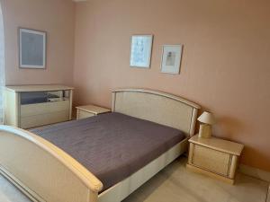 a small bedroom with a bed and two tables at Belle Maison avec vue magnifique , séjour pleine nature gd jardin in Cressat