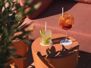 a table with a drink and a glass on it at Hôtel Liautaud Rooftop Cassis in Cassis
