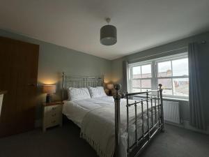 Un dormitorio con una cama y una ventana grande. en Church walk view apartment Filey, en Filey