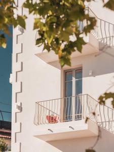 a white building with a balcony and a window at Hôtel Liautaud Rooftop Cassis in Cassis