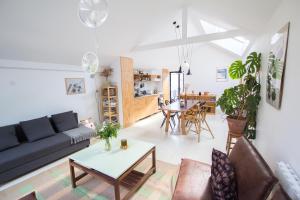 a living room with a couch and a table at Bright & Eco-Friendly Wooden Home, A Peaceful Retreat Near Paris in Montreuil
