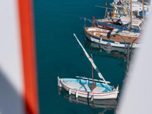 two boats are docked in the water at Hôtel Liautaud Rooftop Cassis in Cassis
