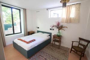 a bedroom with a bed and a window at Bright & Eco-Friendly Wooden Home, A Peaceful Retreat Near Paris in Montreuil