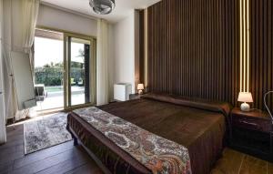 a bedroom with a large bed and a large window at Beautiful Home In Trecastagni in Trecastagni