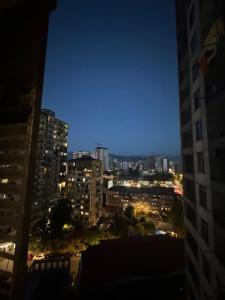 a view of a city skyline at night at Pirosmani Mini Hotel in Batumi
