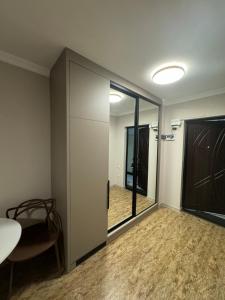a room with a sliding glass door with a table and a chair at Pirosmani Mini Hotel in Batumi
