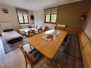 a living room with a table and a couch at Rogla apartma Rdeča kapica in Vitanje