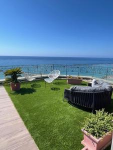 a garden with a view of the ocean at Lolli Palace Hotel in Sanremo