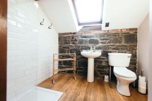 a bathroom with a toilet and a sink at Willows, 3 Bed Cottage with Spacious Kitchen in Lisburn