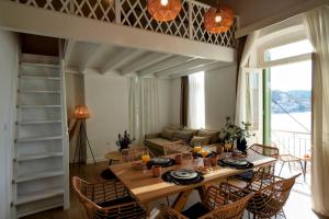 a living room with a table and chairs and a couch at Bella Vista in Symi