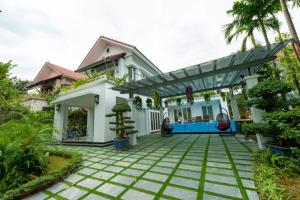 a villa with a swimming pool and a house at Xanh Villa Resort 5 Stars in Nam Giao
