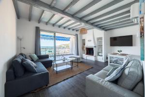 a living room with two couches and a tv at Le plaisir des yeux ! in Cassis