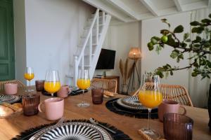 a wooden table with glasses of orange juice on it at Bella Vista in Symi