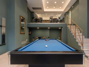 a pool table in a room with a staircase at Miss Marrone City Hotel in Chania