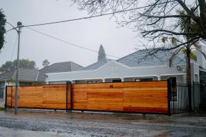 a wooden fence in front of a house at BOSTON HOUSE in Cape Town