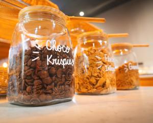 a group of jars filled with different types of nuts at Acta The Clover in Porto