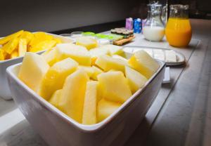 a bowl of cut up fruit on a table at Acta The Clover in Porto