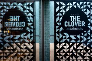 a window with the clover architects sign on it at Acta The Clover in Porto