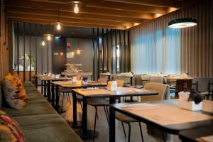 a restaurant with tables and couches and chairs at Acta The Clover in Porto