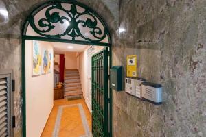 an entrance to a building with a green gate at Apartamentos AMAT - Only Adult - Playa El Bajondillo in Torremolinos
