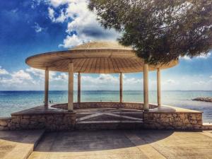 a large umbrella sitting on the beach near the water at Apartamento Encanto Marino in Sant Carles de la Ràpita