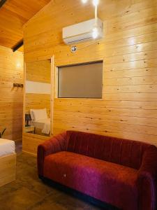 a living room with a couch and a large window at Maleesha Homestay in Ella