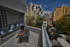 a balcony with a table and a view of a city at iFeel Athens Suites in Athens