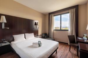 Postel nebo postele na pokoji v ubytování B&B Hotel Arezzo