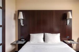 Postel nebo postele na pokoji v ubytování B&B Hotel Arezzo