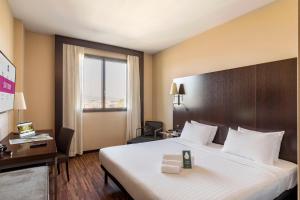 Postel nebo postele na pokoji v ubytování B&B Hotel Arezzo
