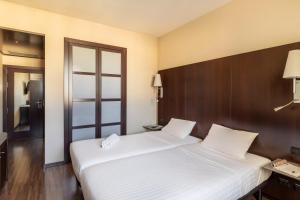 Postel nebo postele na pokoji v ubytování B&B Hotel Arezzo