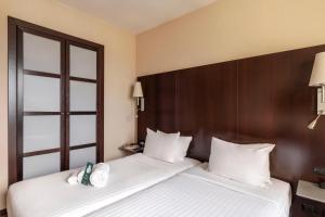 Postel nebo postele na pokoji v ubytování B&B Hotel Arezzo