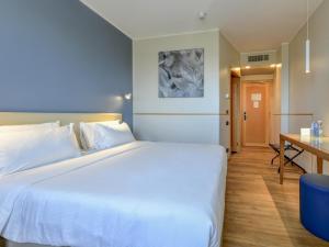 Ένα ή περισσότερα κρεβάτια σε δωμάτιο στο B&B Hotel Quarto d'Altino