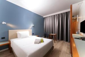 Ένα ή περισσότερα κρεβάτια σε δωμάτιο στο B&B Hotel Quarto d'Altino