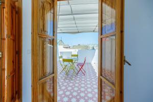an open door to a patio with a table and chairs at Artisan Haven: El Cabanyal Oasis in Valencia