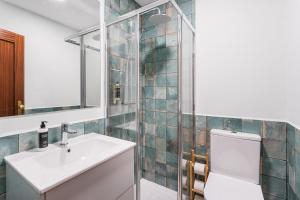 a bathroom with a sink and a toilet and a mirror at Casa Museu da Geada - Rural Hotel in Cinfães +14 photos