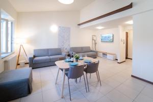 a living room with a couch and a table and chairs at Coco Places Apartments Santa Maria Novella, Centro Storico in Florence