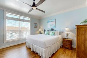 a bedroom with a bed and a ceiling fan at Cottage House #103 in Corpus Christi +21 photos