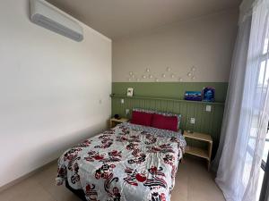 una camera da letto con un letto con cuscini rossi di Casa Lamparina a Santa Fé do Sul Altre 59 foto