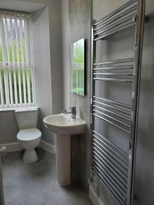 a bathroom with a toilet and a sink at Little Bay View in Oban +6 photos