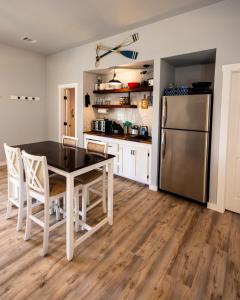 a kitchen with a table and a stainless steel refrigerator at Lake Travis Lakefront Retreat - Hot tub - Boat Ramp - Lakeside Parks in Lago Vista +34 photos