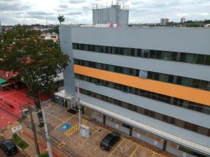 a building with an orange stripe on the side of it at Carandá Hplus Express in Campo Grande