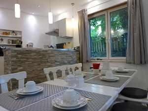 a dining room table with white dishes on it at Auszeit 39 in Stadtoldendorf