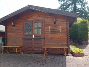 a wooden cabin with a bench and a door at Auszeit 39 in Stadtoldendorf